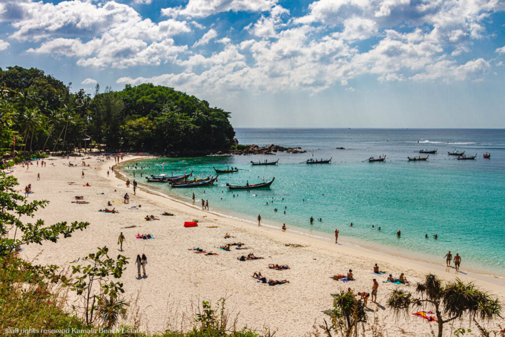 Tranquil Freedom Beach with clear blue waters and lush greenery.