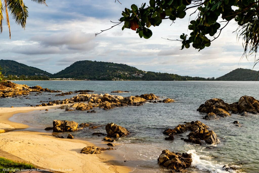 Scenic view of Kalim Beach with rocky shoreline and clear waters.